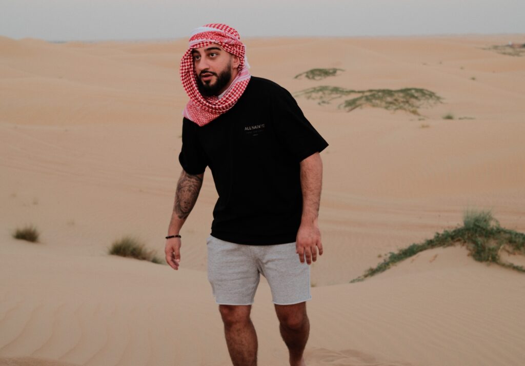 Ali M Saleh walking through the desert